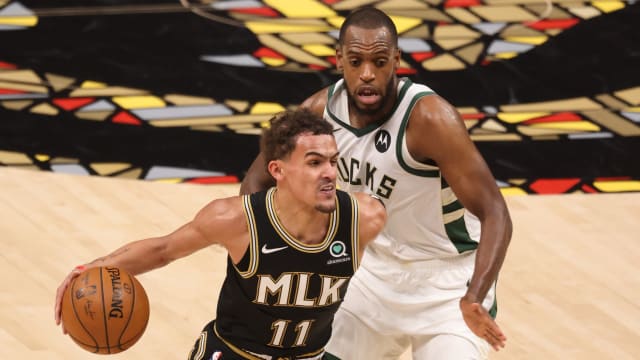 Atlanta Hawks guard Trae Young (11) drives against Milwaukee Bucks forward Khris Middleton (